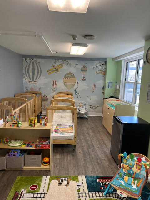 Warm and inviting children's playroom at Growing Minds, equipped for night care.