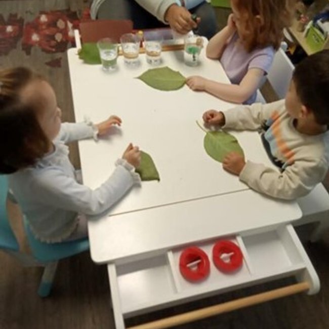Children engaged in a learning activity at a daycare near Glenbrook, CT.