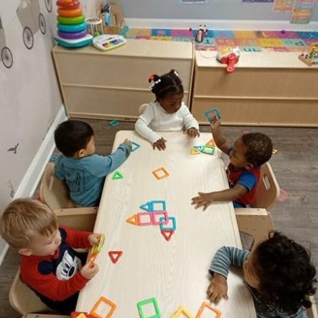 Infants playing with educational toys at a daycare near Darien, CT.