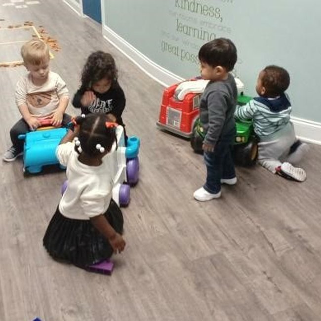 Infants playing with toys at a daycare near Darien, CT, fostering early learning and social development.