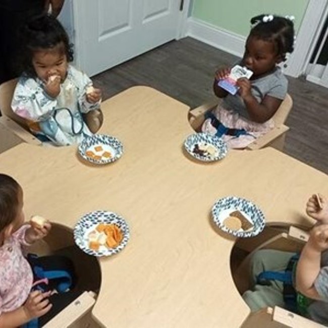 Infants eating snacks at a daycare near Darien CT.