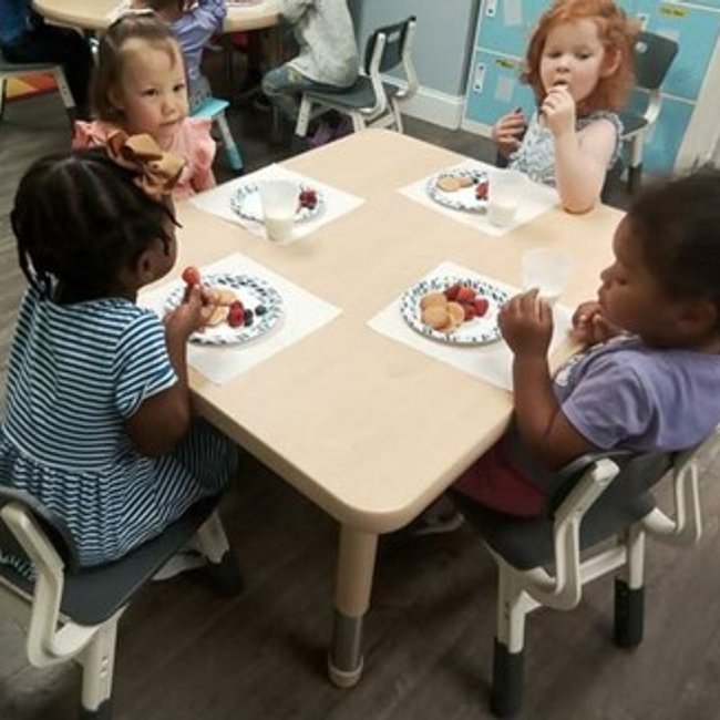Children enjoying snacks at a daycare near Norwalk, CT.