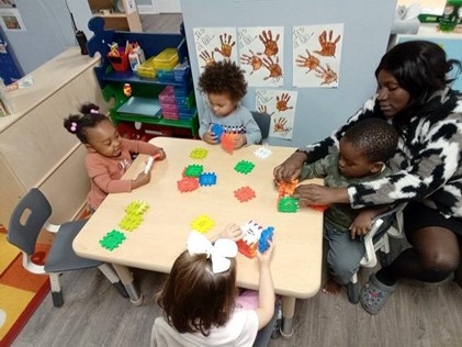 Children and teacher playing with building blocks at a preschool near New Canaan CT.