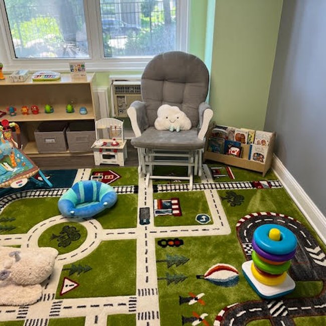 Cozy daycare play area with toys and chair in Norwalk, CT.