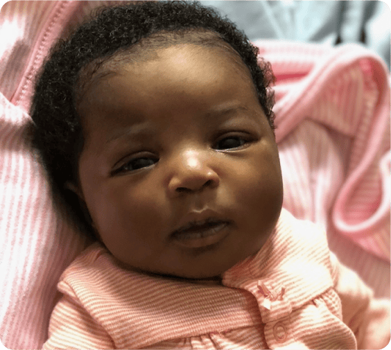 Infant in a pink outfit at daycare in Glenbrook, CT