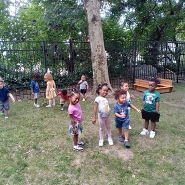 Children playing outside at a Pre K in Glenbrook CT, enhancing kindergarten readiness skills.